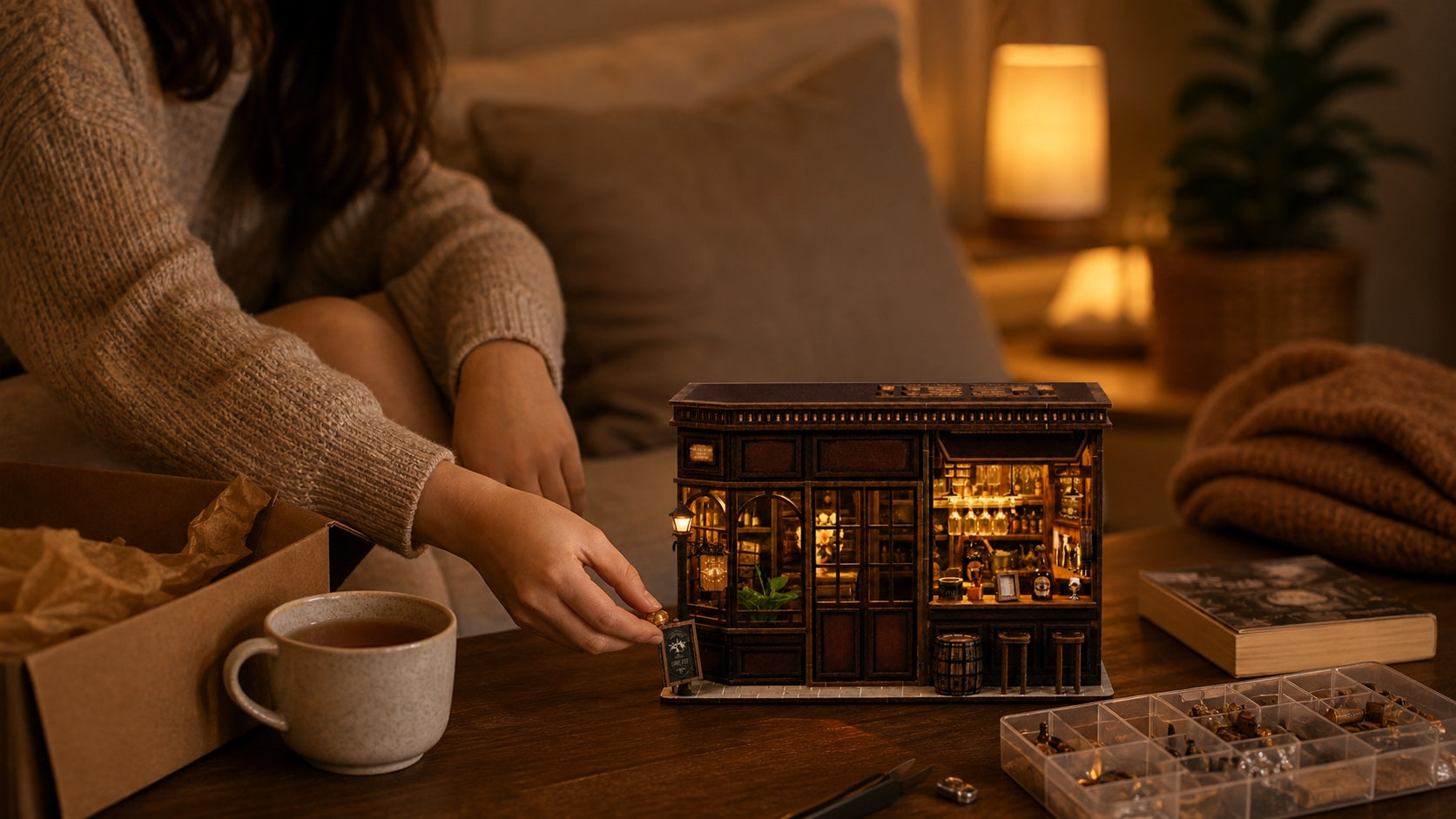 A homebody finishing the Corner Tavern miniature beside tea and an open gift box