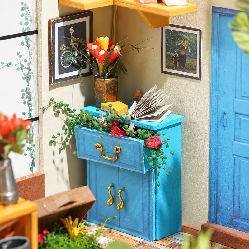 A blue cupboard overflowing with flowers
