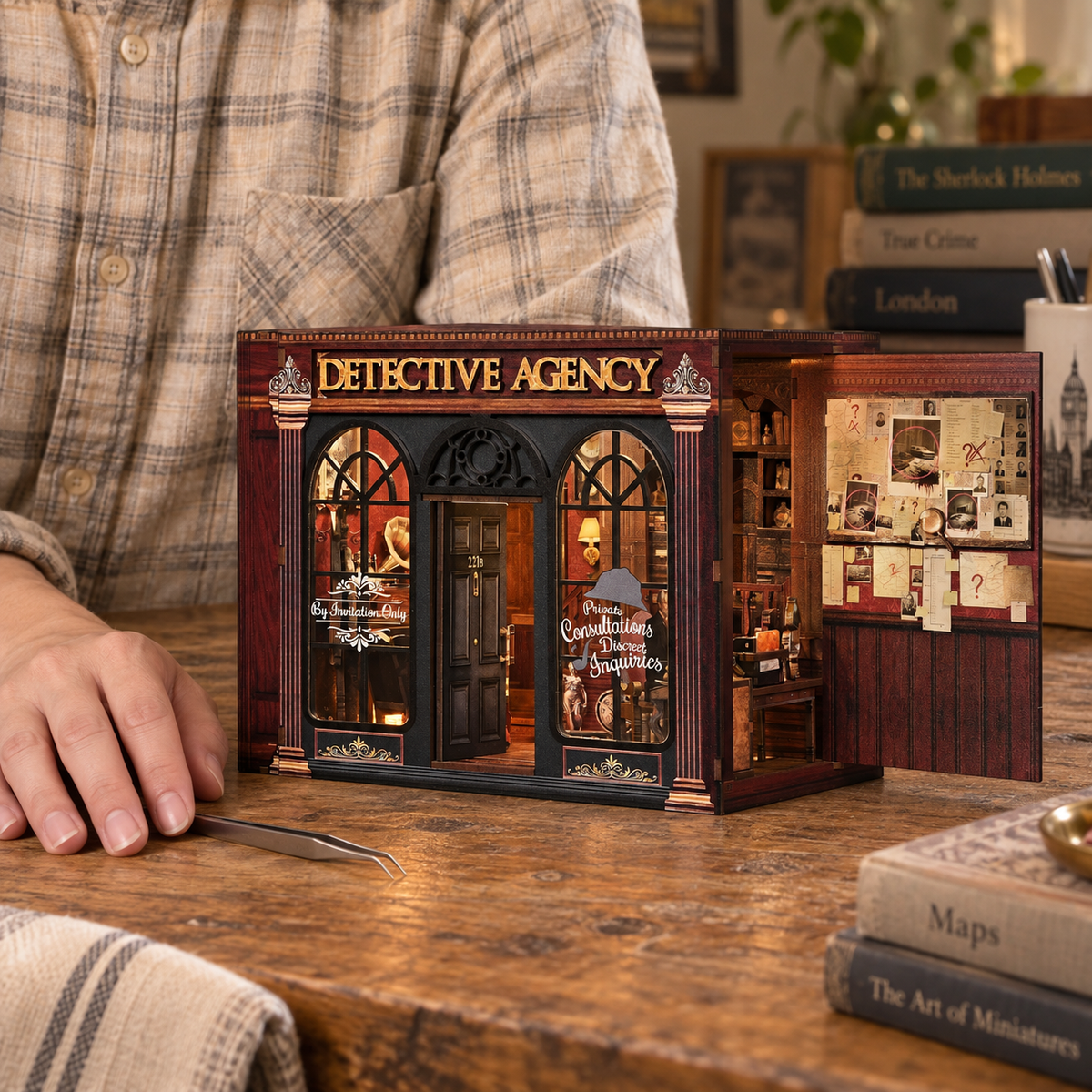 The completed Detective Agency book nook displayed beside a person in a home setting