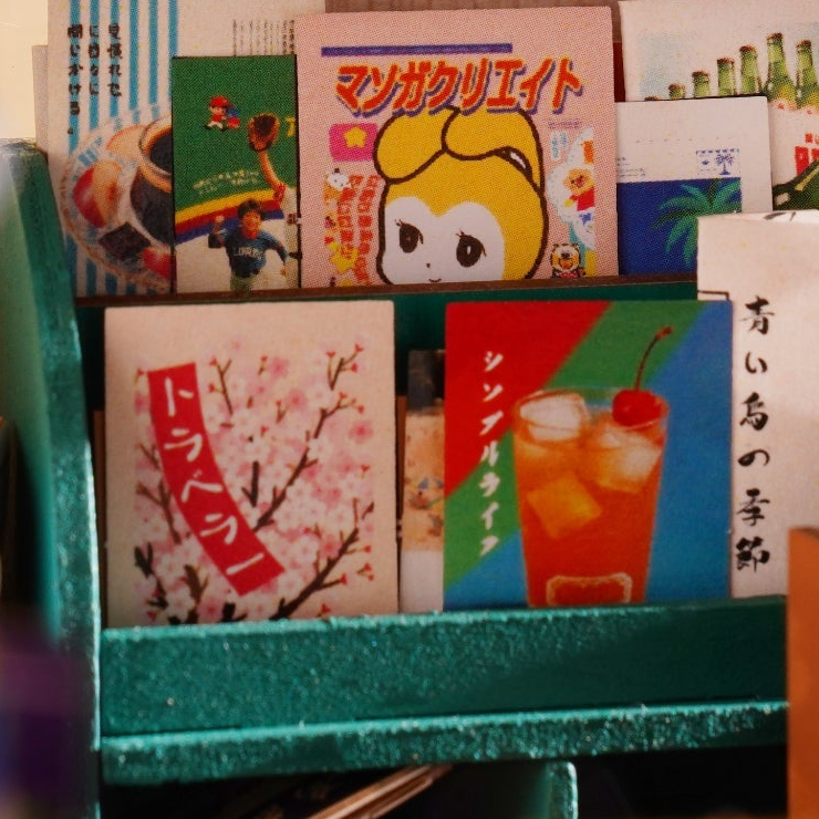 Tiny magazines in a green display rack