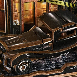 A vintage black car waits outside the book-filled shop.