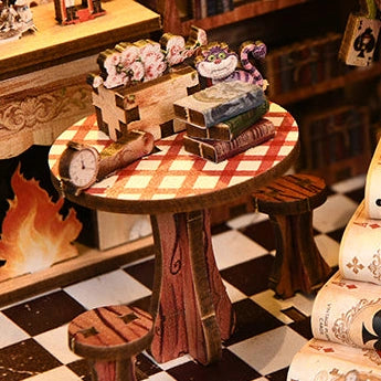 A tea table beside the miniature fireplace