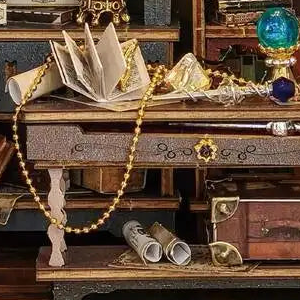 An open book and blue orb on the miniature worktable