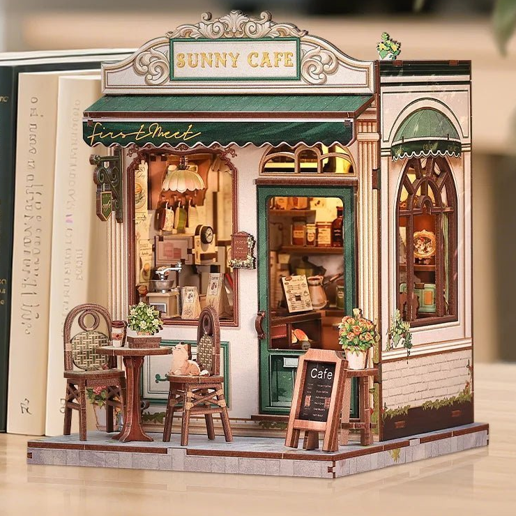 Complete Sunny Cafe displayed beside full-size books on a wooden surface