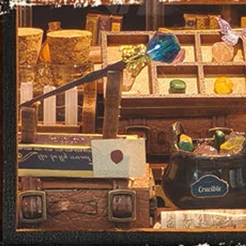 A blue-tipped wand among bottles, books and a sealed letter.