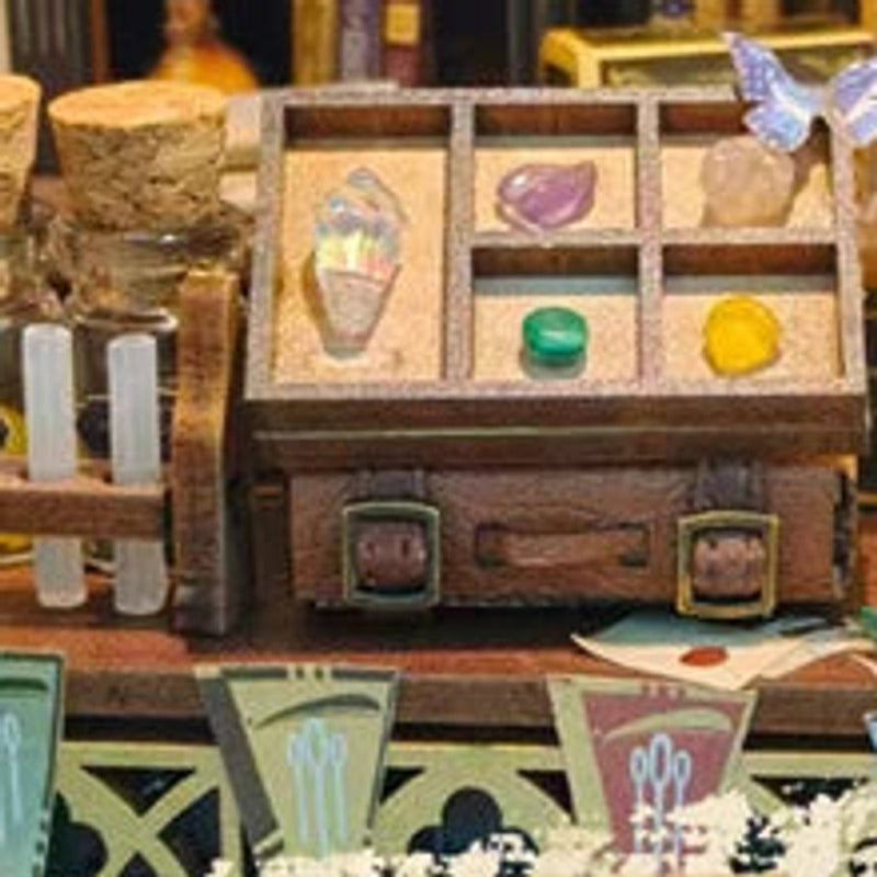 Colourful gem-like curios in a tiny compartmented display.