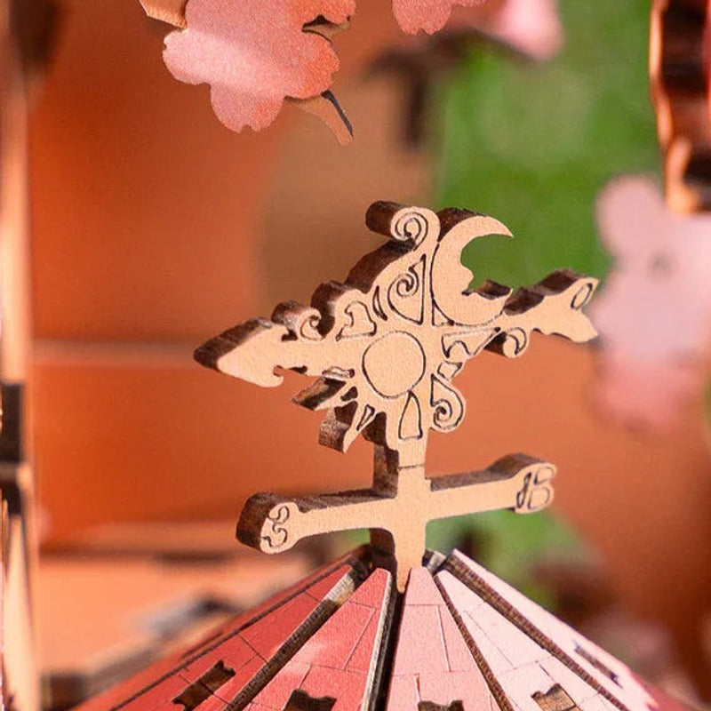 A tiny weather vane above the roof