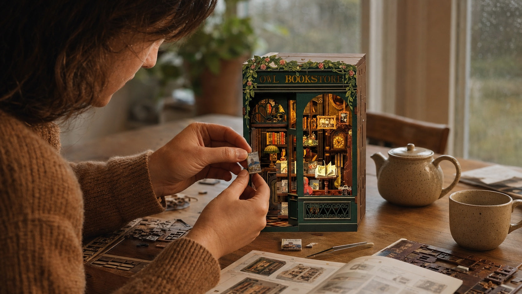 A maker spending a quiet rainy weekend assembling the Owl Bookstore miniature book nook at a table