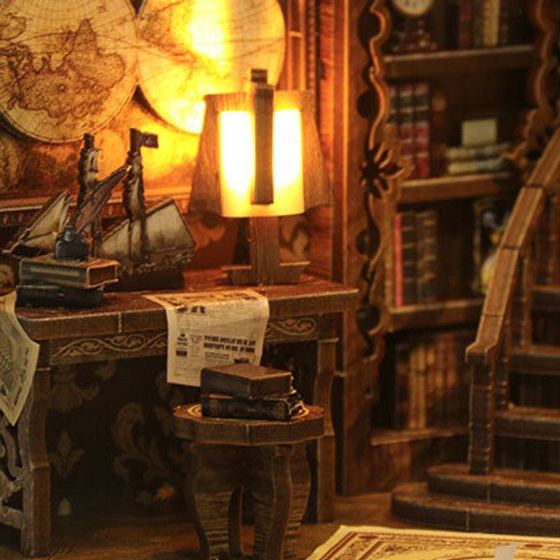 Lamplight falls across the little desk beside the stairs.