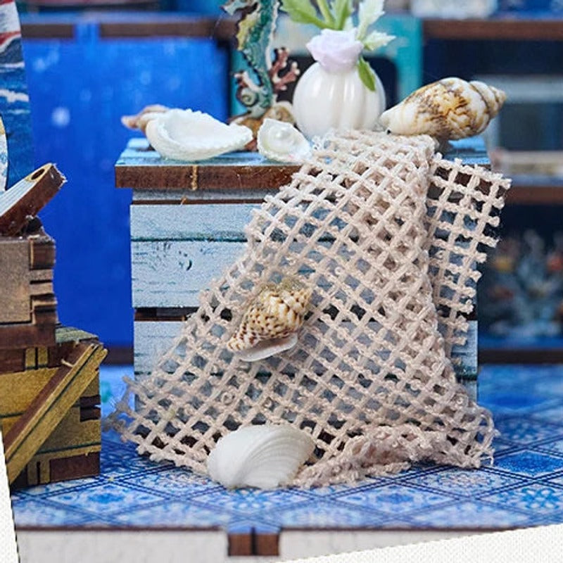 Shells and fishing net draped over a little wooden cabinet.