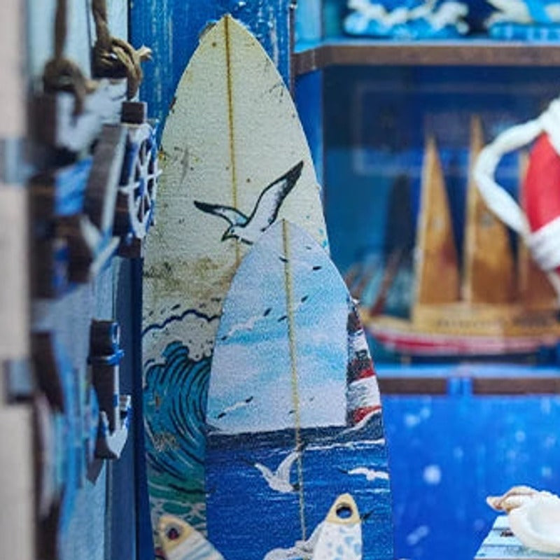 A miniature surfboard waiting by the blue shelves.
