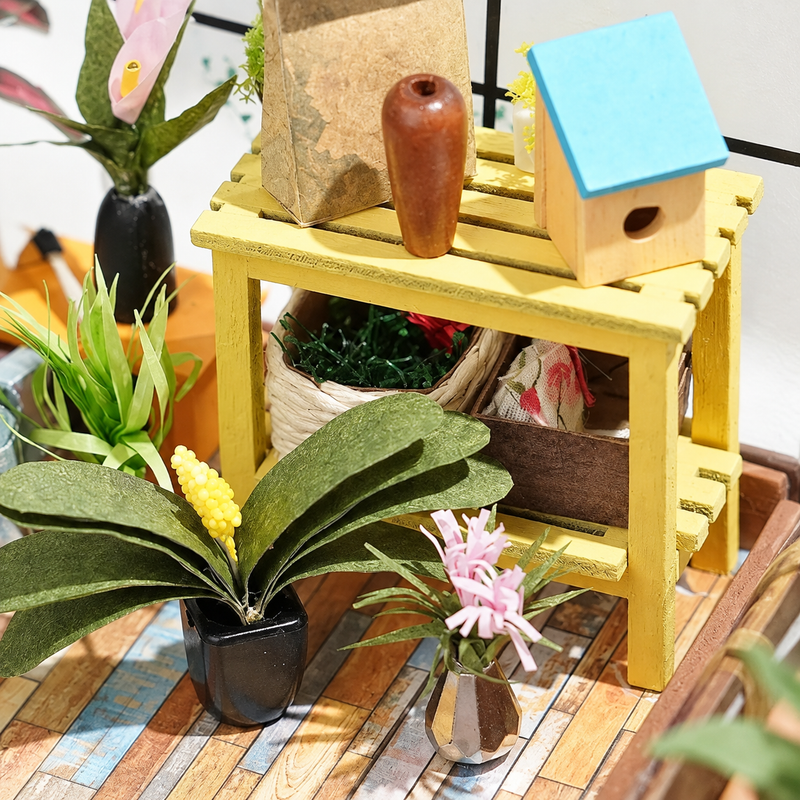 A tiny birdhouse on the potting table