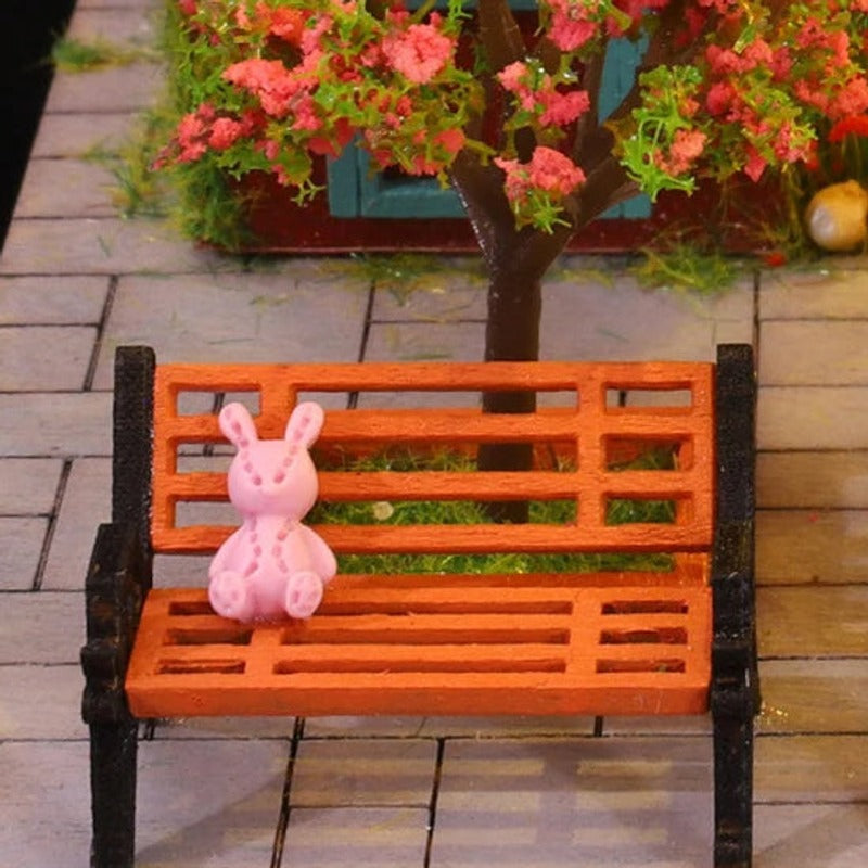 A pink rabbit on the garden bench
