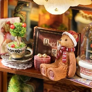 A tiny teddy beside a teacup garden.