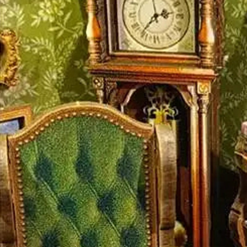A green reading chair beneath a vintage clock.