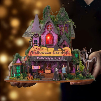 Halloween Night miniature held in two hands to show the completed haunted house and its base
