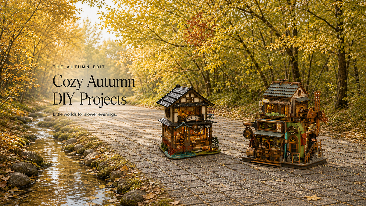 Cozy Autumn DIY Projects – two miniature houses beside a woodland stream.