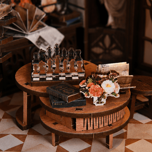 Chess, flowers and books on a round table