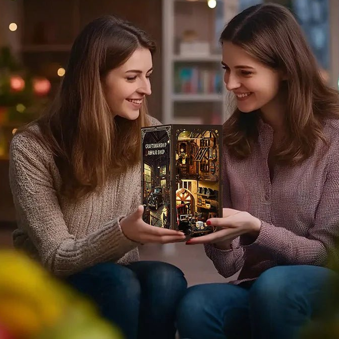 Two women holding the completed Craftsmanship Repair Shop in a gift-giving scene