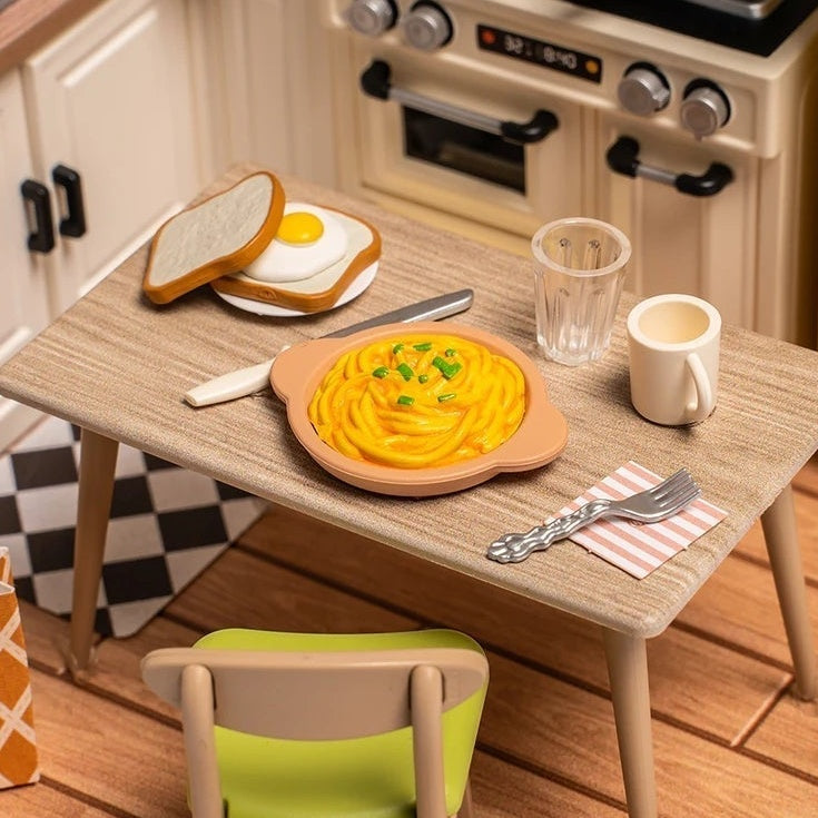 Miniature pasta, egg-topped toast and dishes set out for a meal.