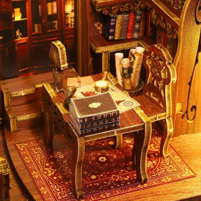 A quill, little books and papers cover the writing desk.