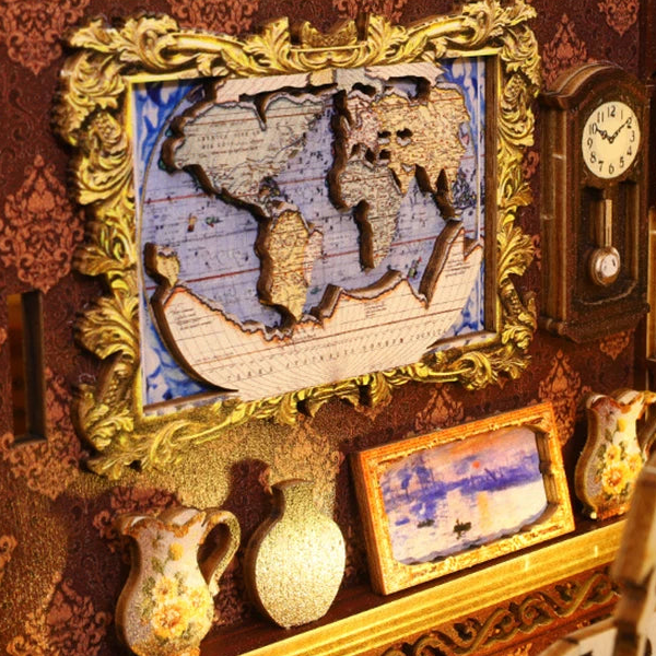 A framed world map above little vases and a landscape picture.