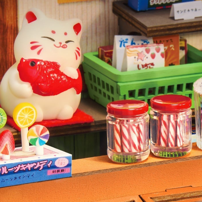 A lucky cat watching over the sweet jars