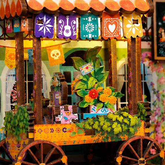 A flower cart beneath patterned flags