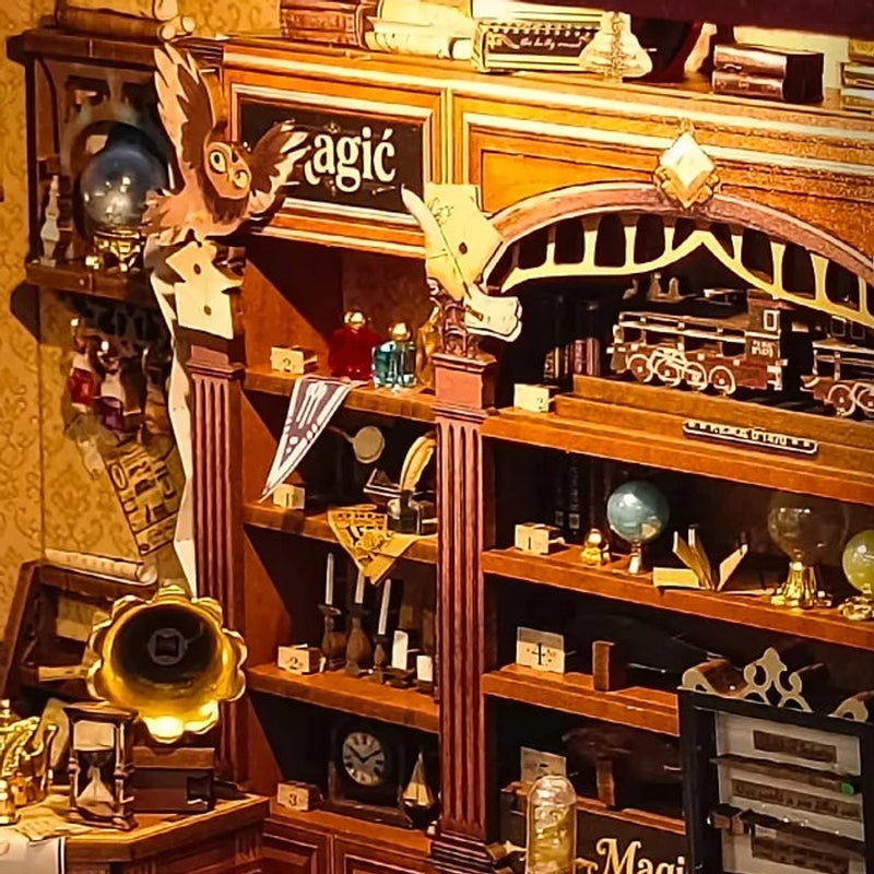 A little train sits among globes, books and bottles.