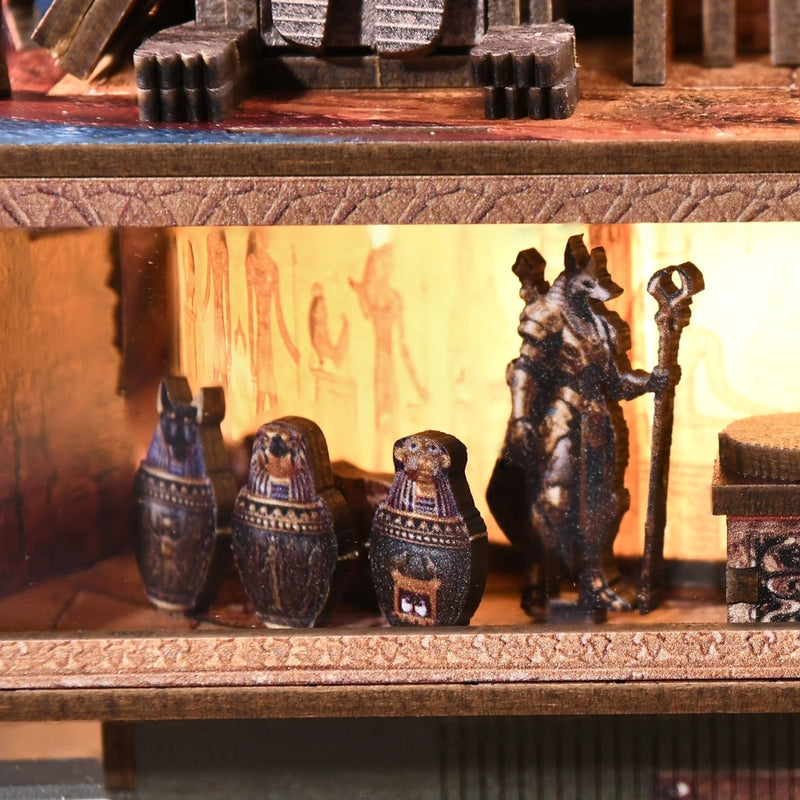 Three painted jars stand beside a jackal-headed guardian.