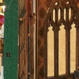 A pointed lattice window beside the bookshelves