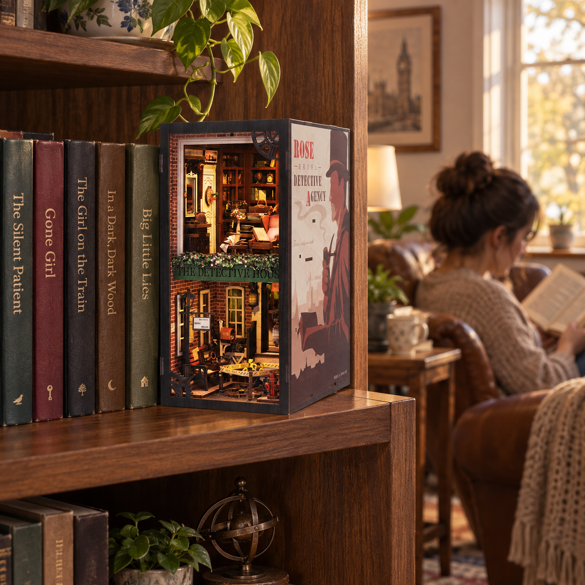 Rose Detective Agency book nook beside mystery novels on a wooden bookshelf, with an adult reading nearby.