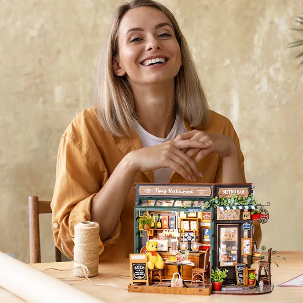 Finished Tipsy Restaurant miniature displayed in front of its maker