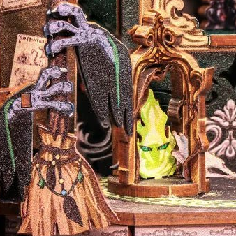 A broom and a green flame motif