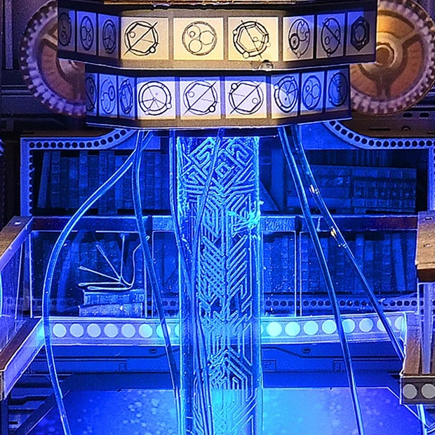 A blue column beneath patterned rings