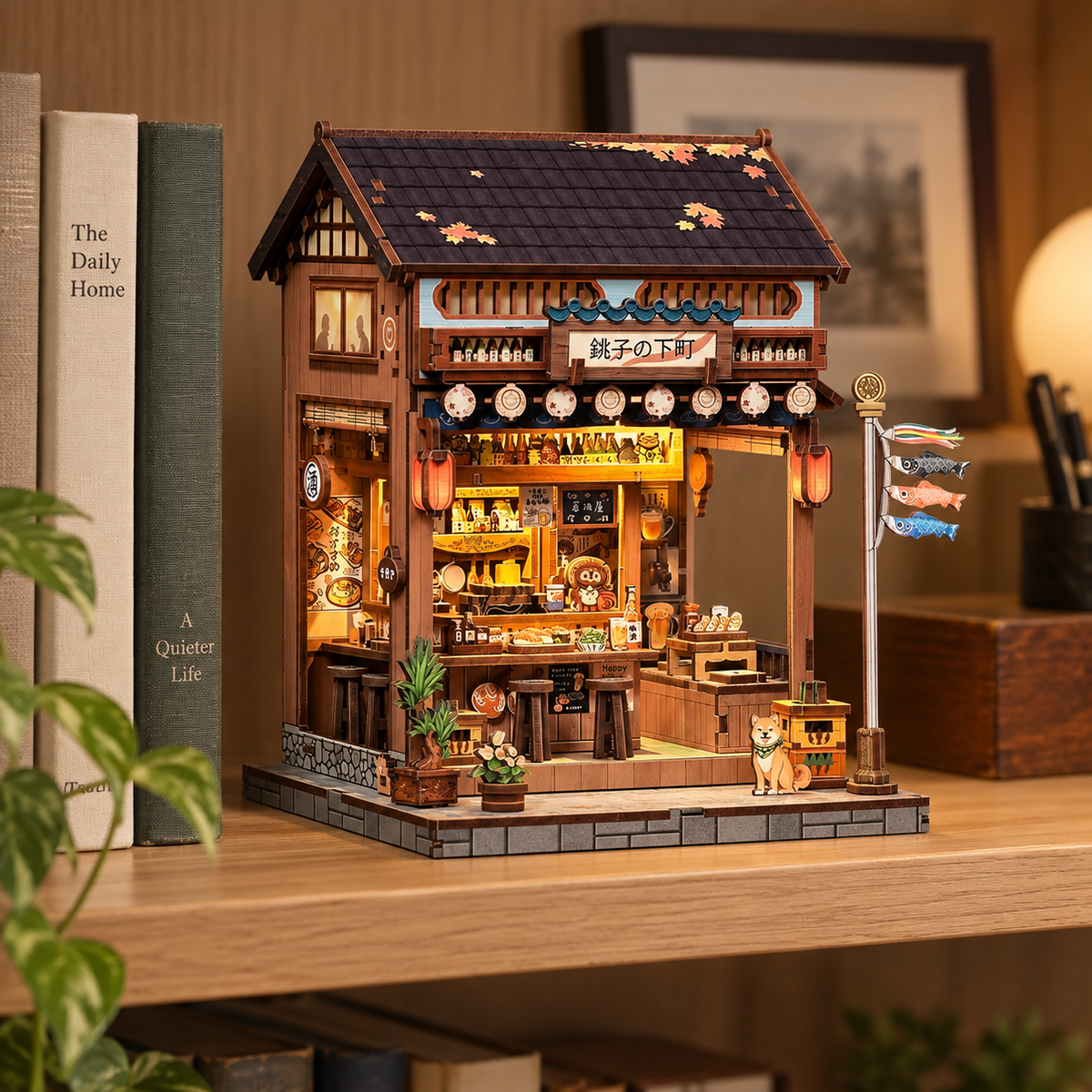 Old Town Choshi miniature displayed on a wooden shelf beside real books