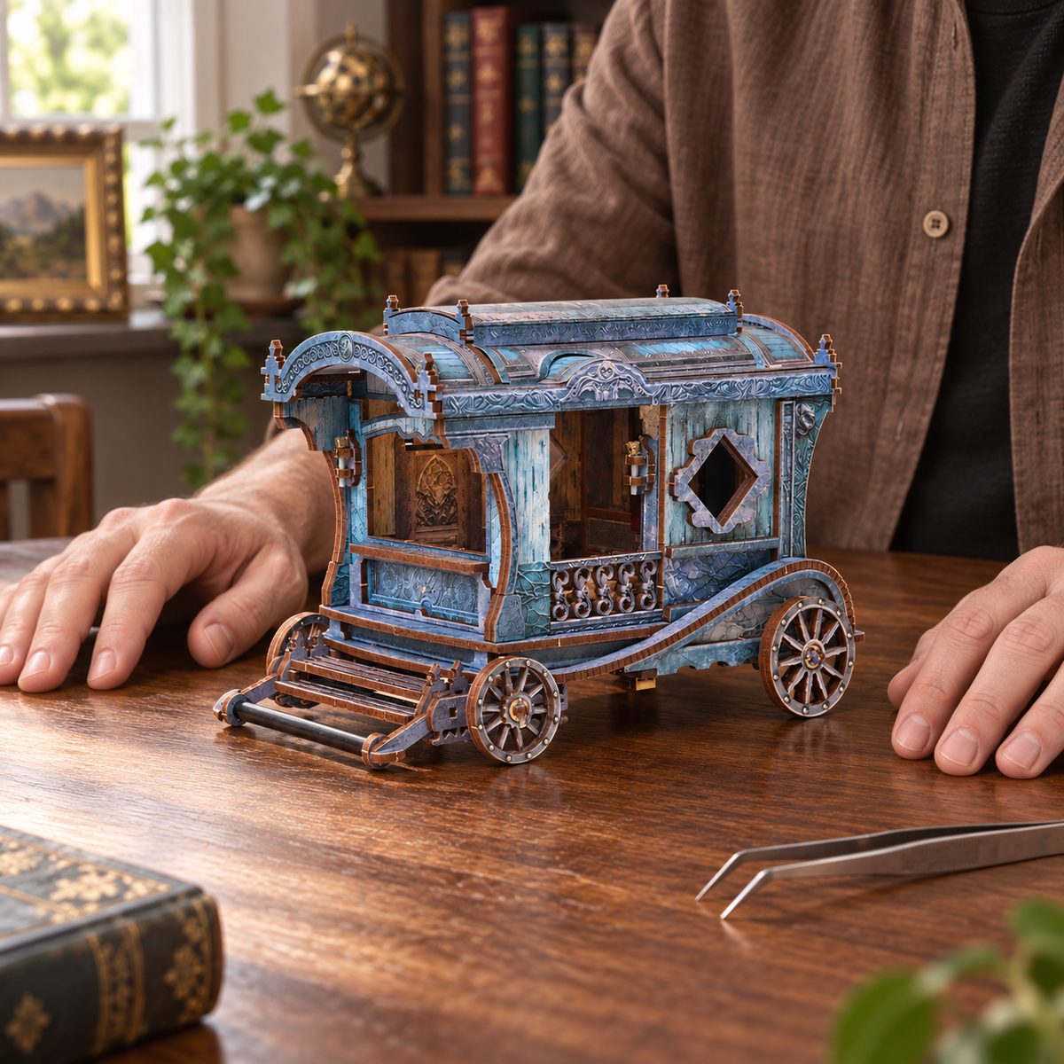An adult maker resting their hands beside the fully completed Onyx Dragon Carriage