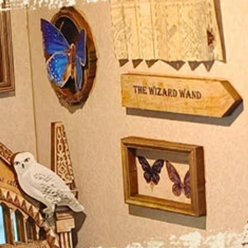 Framed butterflies beside a wizard's sign and a little owl.