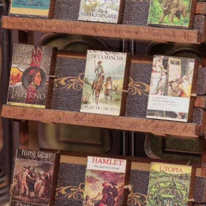 Little book covers line the freestanding display shelf.