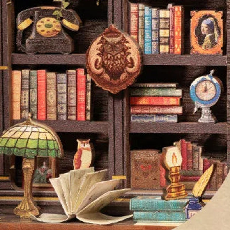 A green-shaded lamp and the little owl among the books.