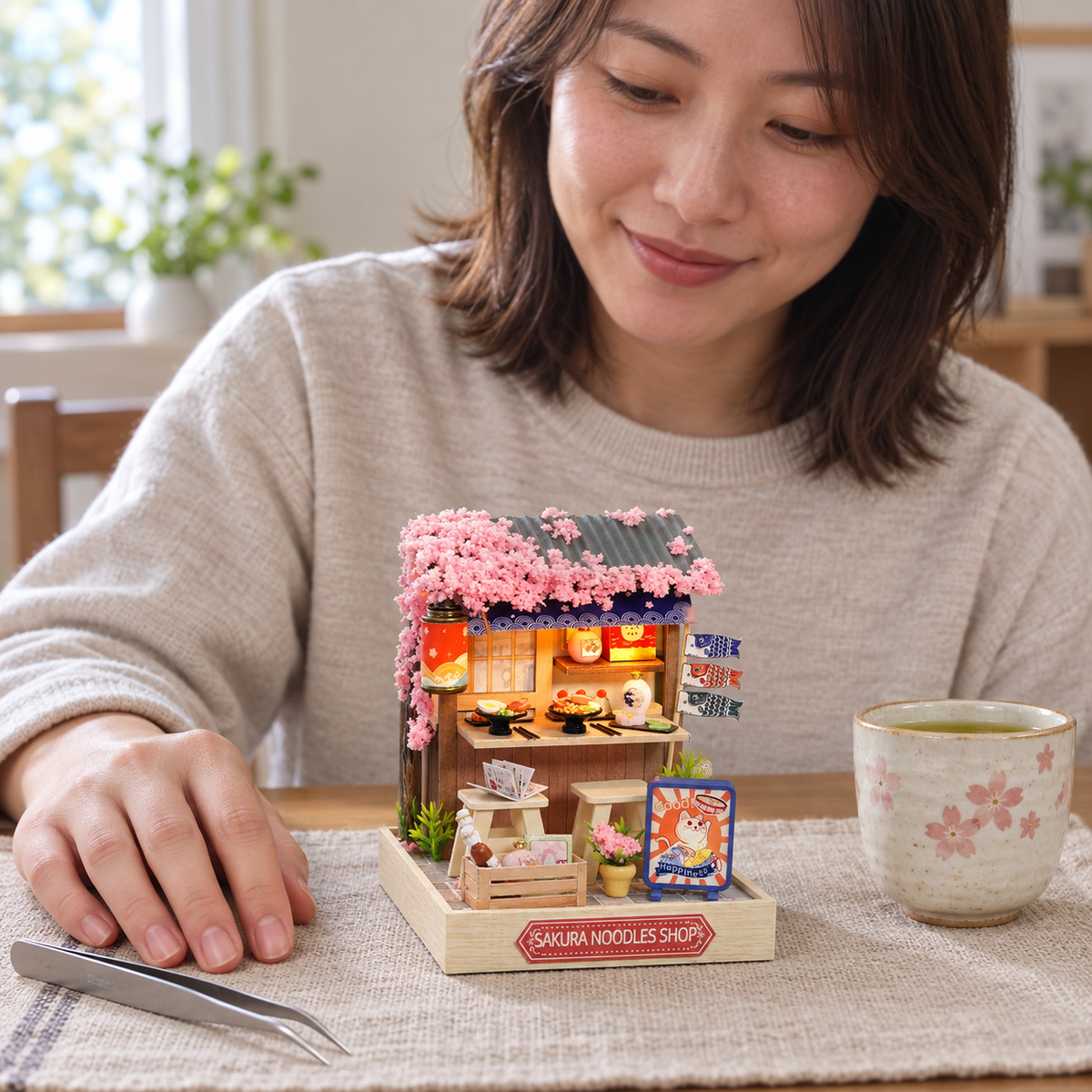 Sakura Noodles Shop — completed miniature in a sharing scene (AI-assisted visualization)