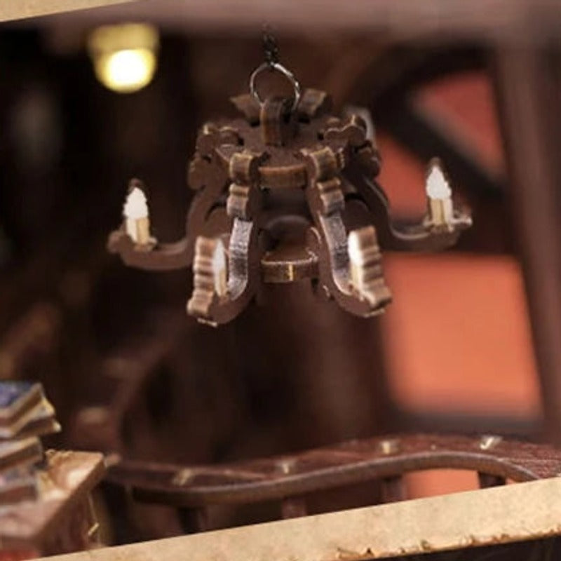 A chandelier above the little tables